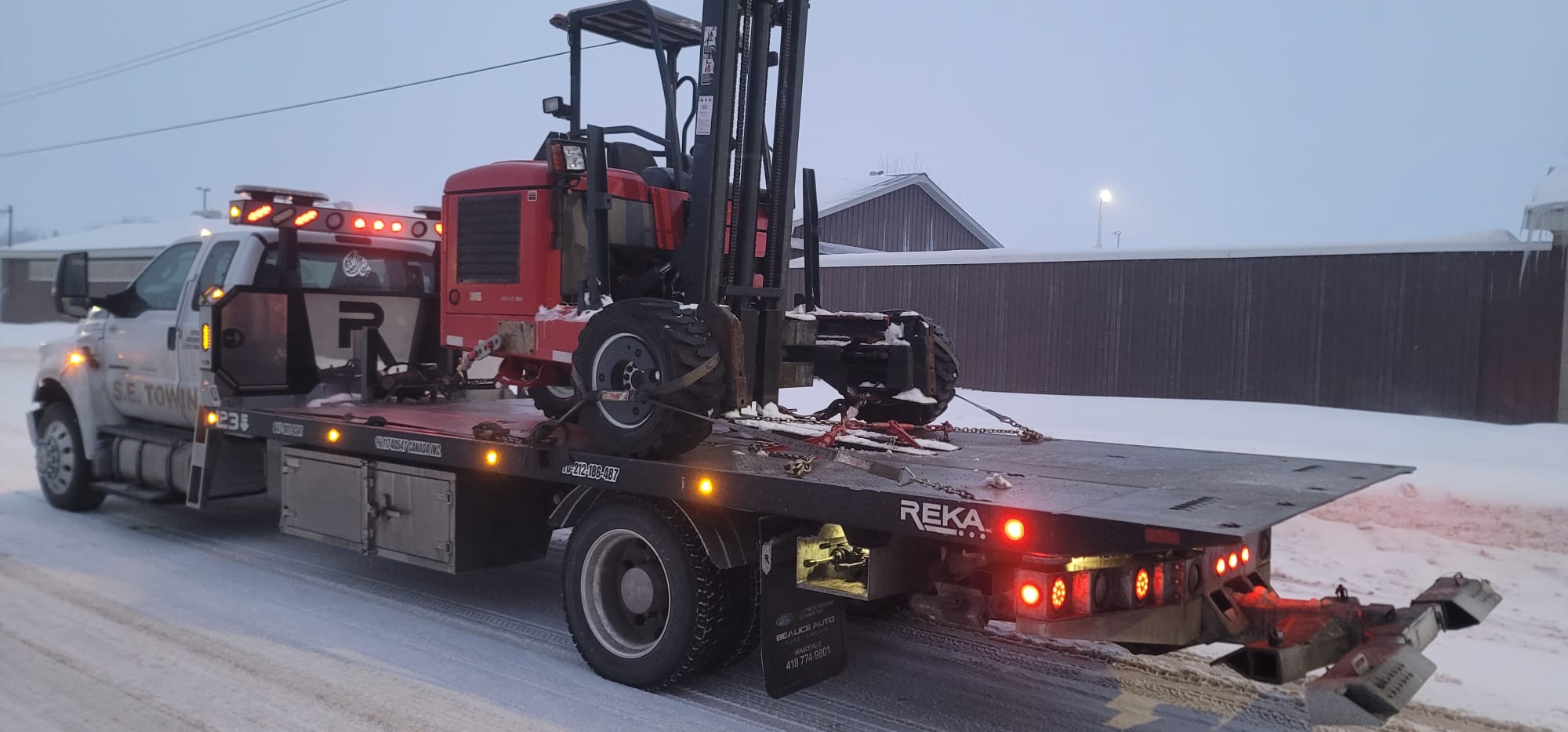 Audi S4 luxury sedan loaded on S.E. Towing F-750 flatbed in Whitby