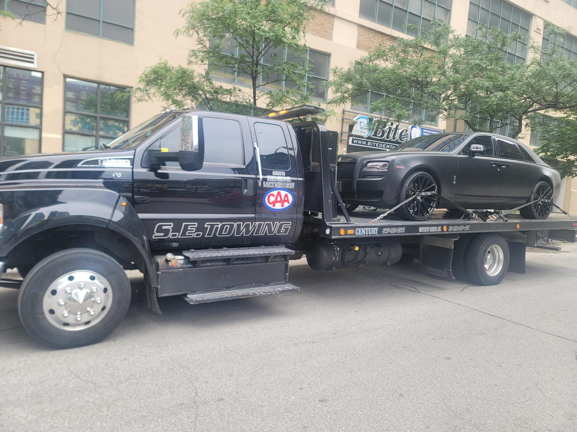 S.E. Towing flatbed transporting a Rolls-Royce in Toronto